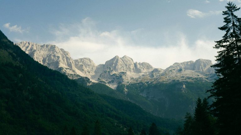 Breathtaking view of the Albanian Alps at Valbonë, showcasing rugged peaks and lush forests.